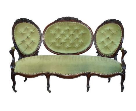 Victorian carved walnut framed triple cameo back sofa upholstered in pale green dralon and standing on cabriole supports   Co