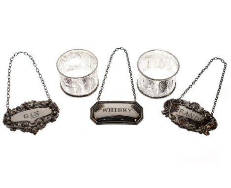 Three 20th Century silver decanter labels and two white metal napkin rings   Condition: 