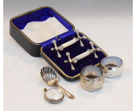 Pair of Victorian silver and mother-of-pearl knife rests, Sheffield 1894, cased, a George V silver caddy spoon, Birmingham 19