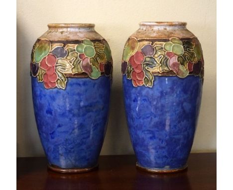 Pair of Doulton Lambeth stoneware ovoid vases, each decorated with a band of stylised foliage in low relief on a mottled blue
