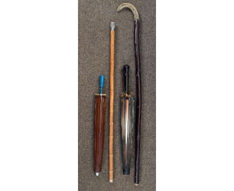 Chinese embossed white metal handled bamboo walking stick, a hiking staff and two parasols   Condition: 