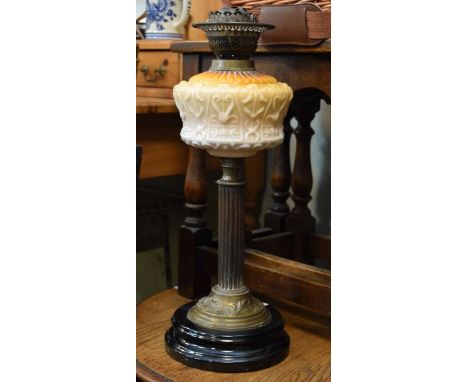 Late Victorian oil lamp having opaque moulded glass reservoir on reeded column and circular ceramic plinth   Condition: 