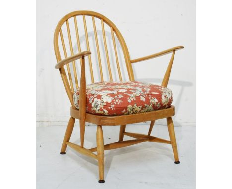 Ercol beech framed stick back open arm chair having upholstered seat   Condition: 