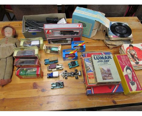 A selection of vintage toys to include an English rag doll with velveteen clothes and printed mask head, various boxed and un