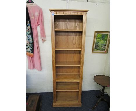 An Ercol light elm tall open bookcase with adjustable shelves and plinth base, 77 x 24