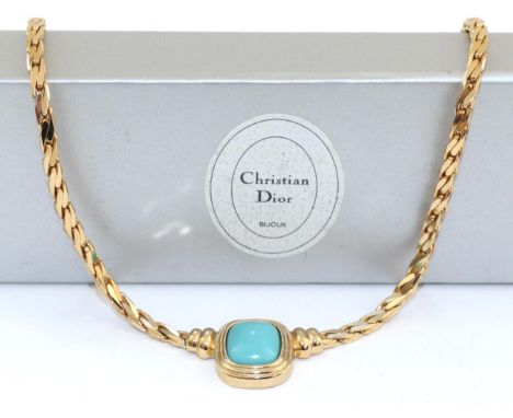 A Christian Dior Necklace, a simulated cabochon turquoise in a rubbed over setting to a flat link chain, length 38cm, in a Ch