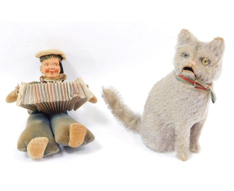 A German early 20thC rag doll, modelled as a sailor boy playing an accordion, 19cm high, together with a vintage clockwork se