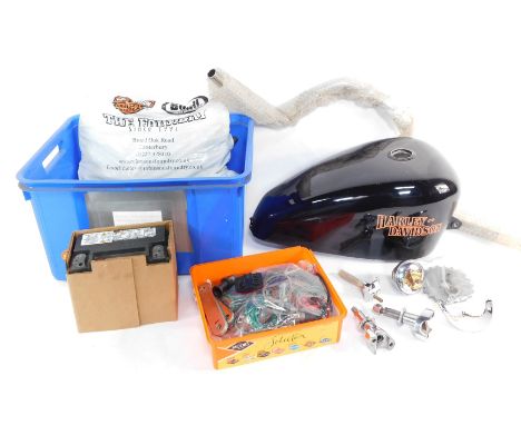 A Harley Davidson fuel tank, handle bar and assorted Harley Davidson spares.