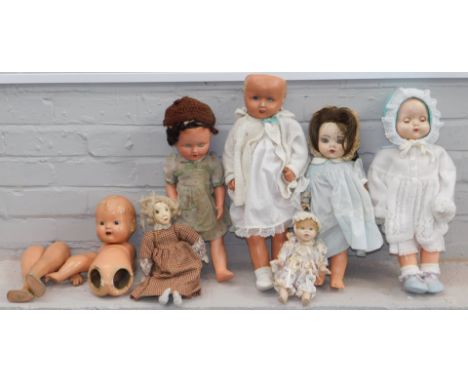 { Group of lots:  1127, 1128, 1129 } A group of ceramic and papier mache headed dolls, all unmarked. (6)