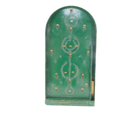 A vintage green painted bagatelle game, with twelve ball bearings.