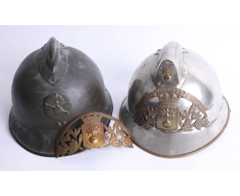 A French fireman's helmet, the crest marked Sapeurs Pompiers D'aulnoye and another helmet, marked RF. Part of the Late Revere