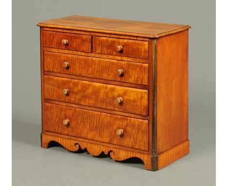 A Victorian mahogany miniature chest of drawers, two short and three long, with shaped apron and bracket feet.  Width 40 cm (