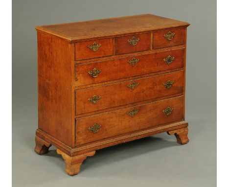 A 19th century mahogany chest of drawers, with moulded edge above three short and three long graduated drawers with brass dro
