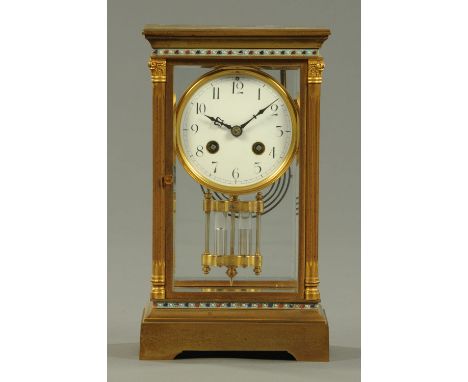 A late 19th century brass and Champleve enamel four glass mantle clock, with two-train movement and mercury weighted pendulum