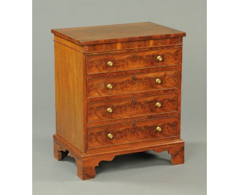 A George III mahogany chest of drawers, converted from a commode, four long drawers with brass knob handles and raised on bra
