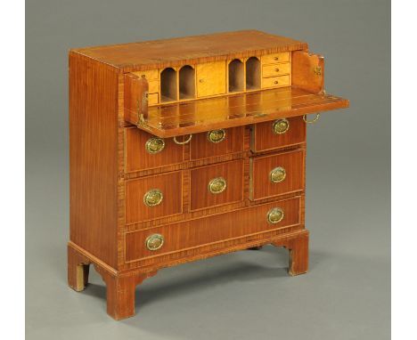 A small George III style walnut crossbanded secretaire chest of drawers, with brass drop handles and raised on bracket feet. 