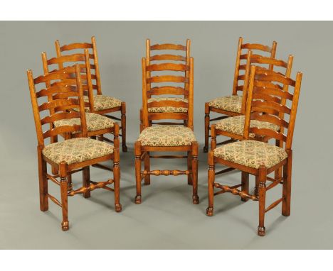 A set of eight oak ladder back dining chairs, in the early 19th century style, each with drop in seat and turned front legs r