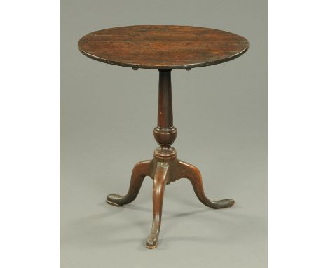 A Georgian country oak oval tripod table, with turned column and three downswept legs terminating in pad feet.  Width 60 cm. 