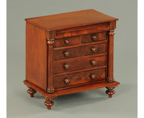 A Victorian mahogany miniature Scotch chest of drawers, with wooden knob handles and column corners.  Width 29.5 cm (see illu