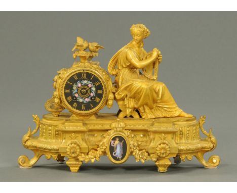A 19th century French gilt spelter mantle clock, figural, the dial being black ceramic and with two-train movement and marked