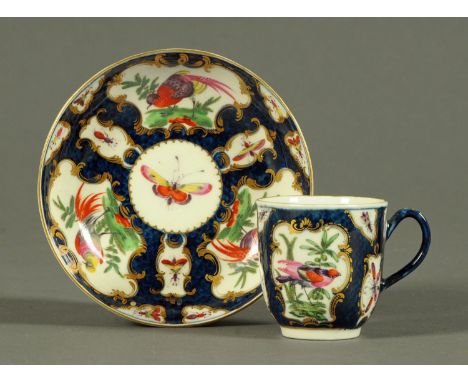 A Worcester Scale Blue porcelain tea cup and saucer, decorated with birds and butterflies (see illustration).   