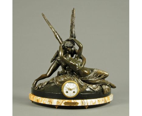 A 19th century French spelter figural mantle clock, "Amour et Psyche", after Canova, the dial marked "Olivaux".  Width 51 cm.
