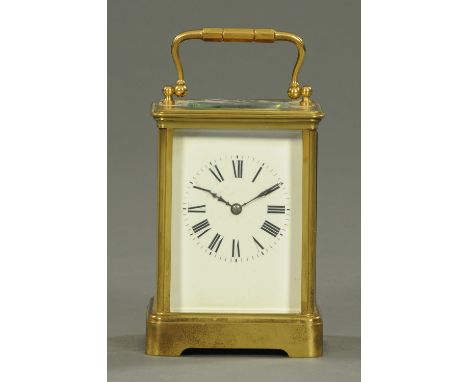 A French brass carriage clock, with two-train movement striking on a single gong.  Height excluding carrying handle 13 cm. 