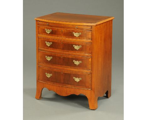 A walnut bowfronted chest of drawers, with slide, circa 1930, four drawers with brass drop handles with shaped backplates and