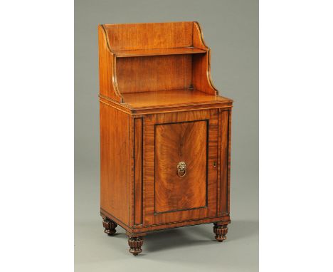 A Regency mahogany side cabinet, with waterfall shelf unit above, with well figured panelled door and raised on short lobed f