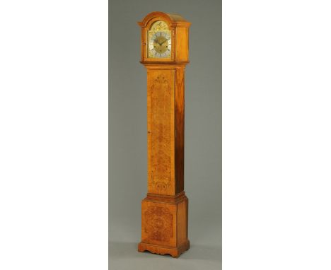 A walnut grandmother clock, with three-train spring driven movement striking on eight gongs, with well figured case.  Height 