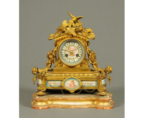 A 19th century French ormolu and porcelain mantle clock, raised on a wooden base.  Width 27 cm (see illustration).  