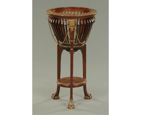 A late Victorian mahogany aspidistra stand, with carved lion masks and low circular shelf.  Diameter 46 cm. 