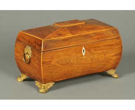 A Regency rosewood tea caddy, of bombe form, with fitted interior and raised on punched brass feet.  Width 31 cm. 