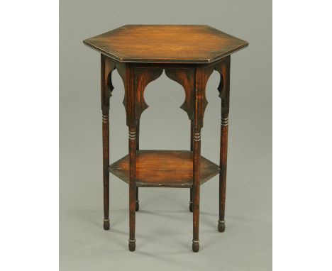 A Liberty style oak octagonal occasional table, two tier, raised on turned legs with pad feet.  Width 47 cm.  CONDITION REPOR