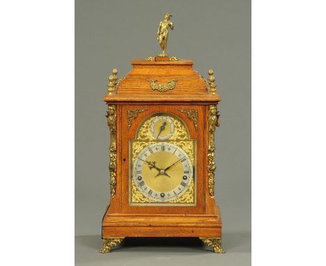 A late Victorian oak bracket clock, with three-train spring driven movement striking on five gongs.  Height including finial 