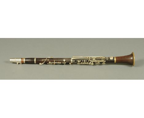 A vintage rosewood clarinet, stamped "Piedominant".  Length 66.5 cm. 