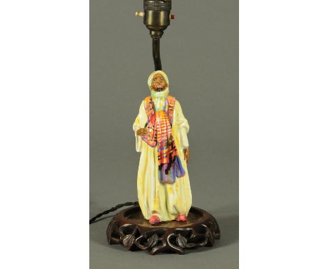 A Royal Doulton figural table lamp, with wooden base.