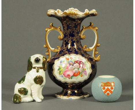 A Derby style twin handled vase, with floral decoration, a Carltonware match striker and a miniature Staffordshire Spaniel.  