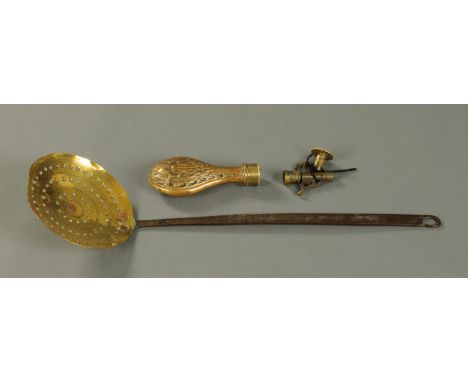 A Victorian brass and copper powder flask, and a brass and iron handled skim.  