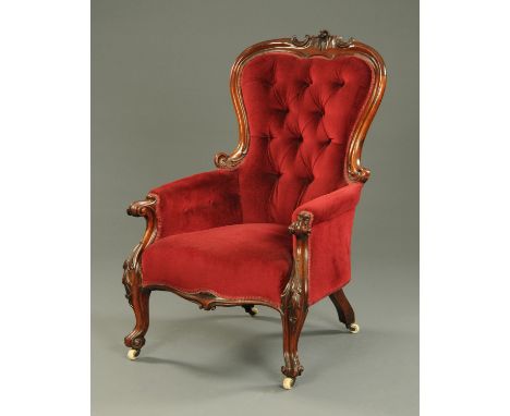 A Victorian walnut open armchair, with exposed moulded showframe, upholstered back, arms and seat and raised on front cabriol