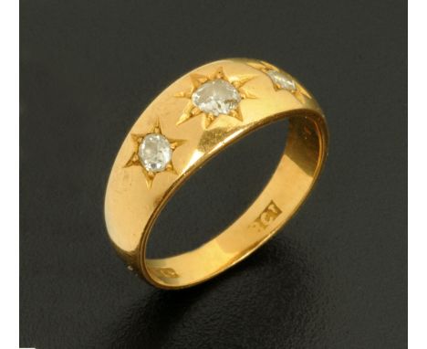 An 18 ct gold three stone diamond ring.  Size J/K. CONDITION REPORT: Generally good condition.  Very clear hallmarks, no sign