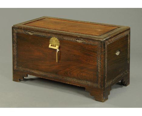 An early 20th century Burmese camphorwood trunk, with brass lock and raised on bracket feet.  Width 101 cm. 