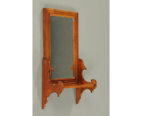 A 19th century walnut wall mounted hall mirror, with shelf and fretwork side supports.  Width 28 cm. 