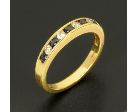 An 18 ct yellow gold sapphire and diamond half eternity ring, size J/K.