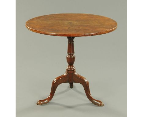 A George III mahogany tripod table, with circular top, turned column and three downswept legs terminating in pad feet.  Diame