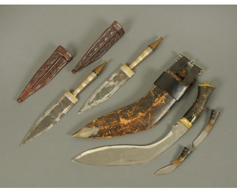 A vintage Gurkha Kukri knife, and two Eastern daggers.
