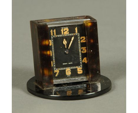 A LeCoultre Art Deco desk clock, with simulated tortoiseshell stand.  Height 6.5 cm. 