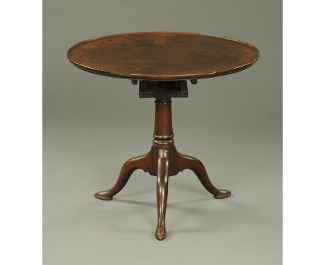 A George III mahogany tripod table, with snap action to turned column with three downswept legs terminating in pad feet.  Dia