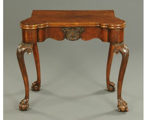 A mahogany card table, in the George II style, circa 1930, with turnover top fitted with counter wells and with serpentine fr