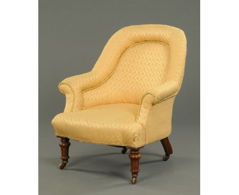 A Victorian ladies chair, upholstered in pale patterned fabric with piping and raised on turned front legs terminating in cas